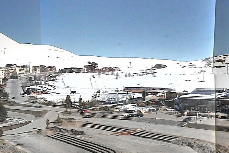 An aerial view of a snowy mountain town with a watermark that says ' tld ' on it