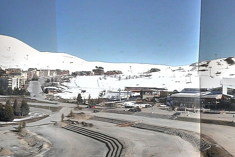 An aerial view of a snowy mountain town with a watermark that says ' tld ' on it