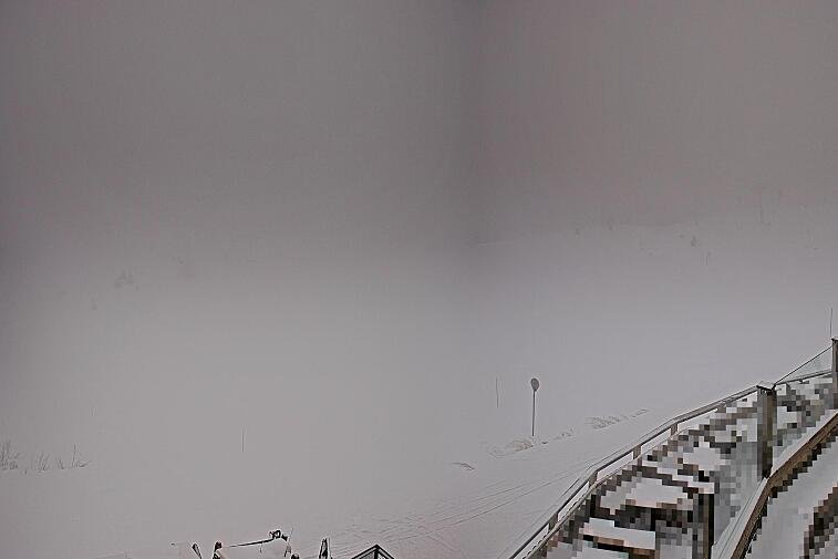 A screen shot of a snowy mountain with a time stamp at the bottom