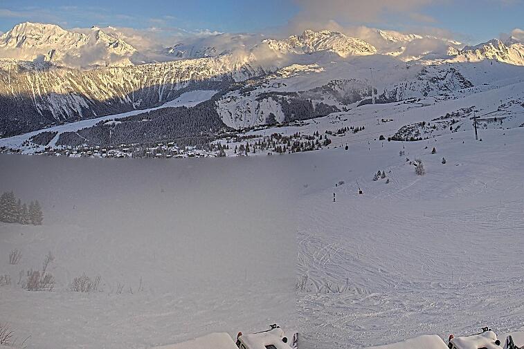 Birds-eye webcam view of conditions on the pistes above Courchevel 1650. The top station of the Ariondaz cable car is visible on the left-hand side of the shot.
