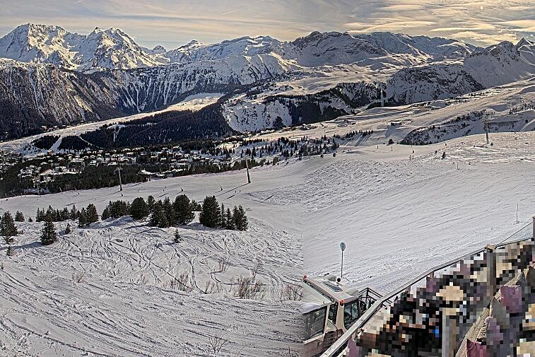 Birds-eye webcam view of conditions on the pistes above Courchevel 1650. The top station of the Ariondaz cable car is visible on the left-hand side of the shot.