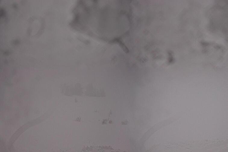 Birds-eye webcam view of conditions on the pistes above Courchevel 1650. The top station of the Ariondaz cable car is visible on the left-hand side of the shot.