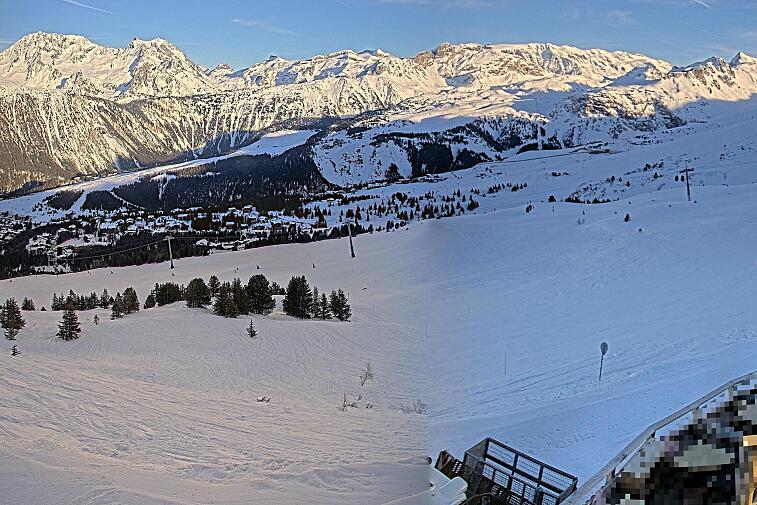 Birds-eye webcam view of conditions on the pistes above Courchevel 1650. The top station of the Ariondaz cable car is visible on the left-hand side of the shot.