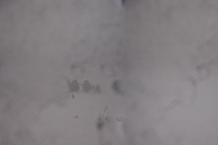 Birds-eye webcam view of conditions on the pistes above Courchevel 1650. The top station of the Ariondaz cable car is visible on the left-hand side of the shot.