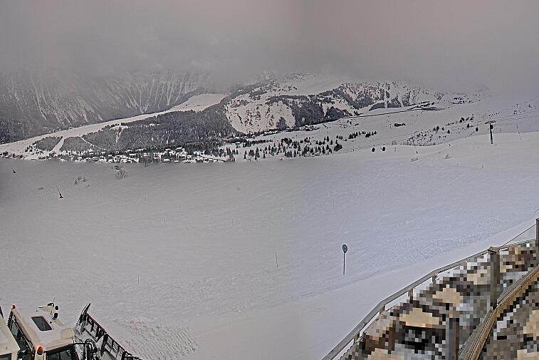 Birds-eye webcam view of conditions on the pistes above Courchevel 1650. The top station of the Ariondaz cable car is visible on the left-hand side of the shot.