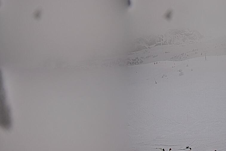 Birds-eye webcam view of conditions on the pistes above Courchevel 1650. The top station of the Ariondaz cable car is visible on the left-hand side of the shot.