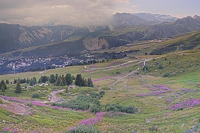 Birds-eye webcam view of conditions on the pistes above Courchevel 1650. The top station of the Ariondaz cable car is visible on the left-hand side of the shot.