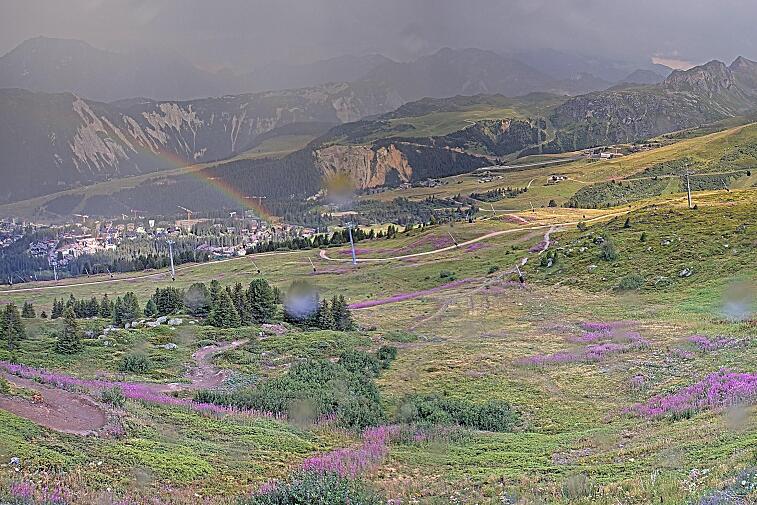 Birds-eye webcam view of conditions on the pistes above Courchevel 1650. The top station of the Ariondaz cable car is visible on the left-hand side of the shot.