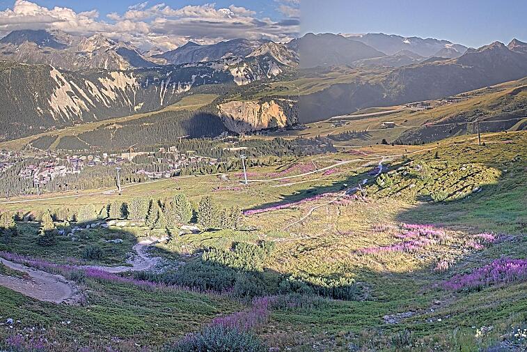 Birds-eye webcam view of conditions on the pistes above Courchevel 1650. The top station of the Ariondaz cable car is visible on the left-hand side of the shot.