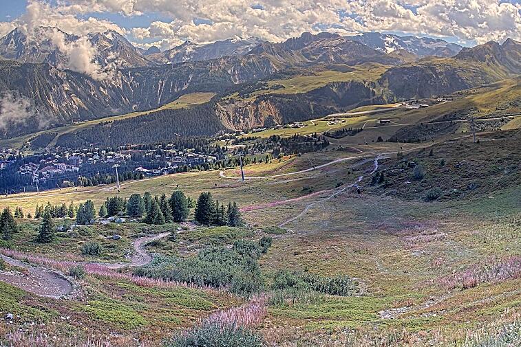 Birds-eye webcam view of conditions on the pistes above Courchevel 1650. The top station of the Ariondaz cable car is visible on the left-hand side of the shot.