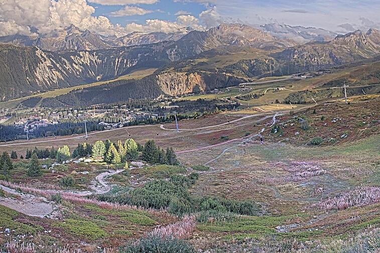 Birds-eye webcam view of conditions on the pistes above Courchevel 1650. The top station of the Ariondaz cable car is visible on the left-hand side of the shot.
