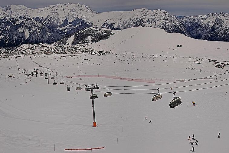 A black and white photo of a ski lift in the mountains