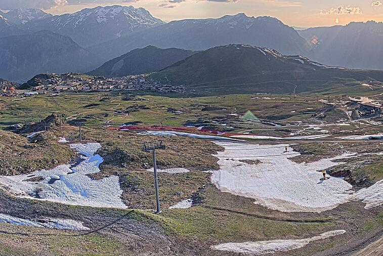 Webcam view of the whole of the Marmottes 2300m ski area and piste-front in the foreground, and the main gondola the Grand Rousses is on the far right along with La Folie Douce restaurant terrace