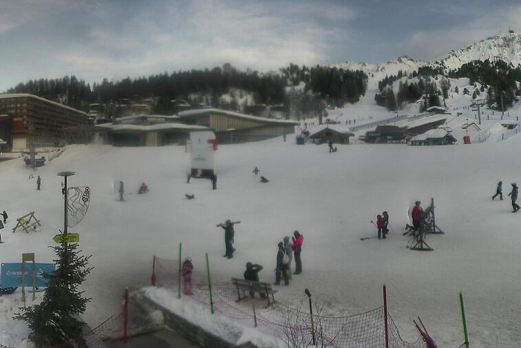 Webcam view across La Plagne centre piste-front. On the left you'll be able to see local ski schools giving lessons. The peak in the middle is La Grande Rochette. On the right is the Stade piste.