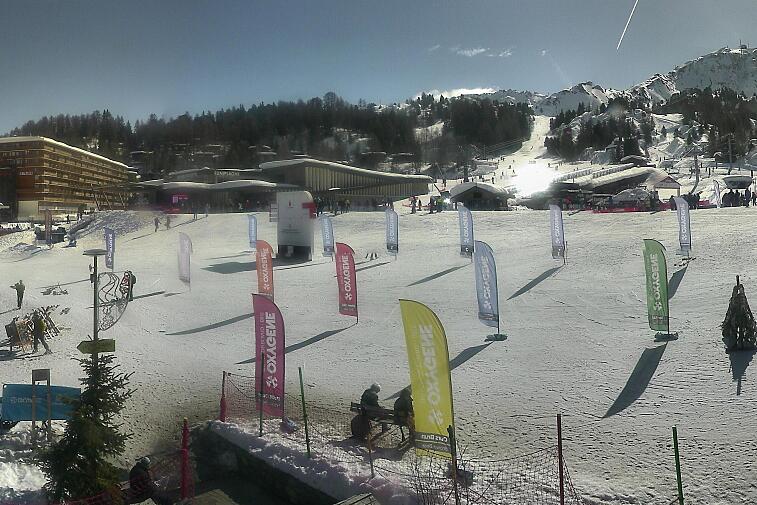 Webcam view across La Plagne centre piste-front. On the left you'll be able to see local ski schools giving lessons. The peak in the middle is La Grande Rochette. On the right is the Stade piste.