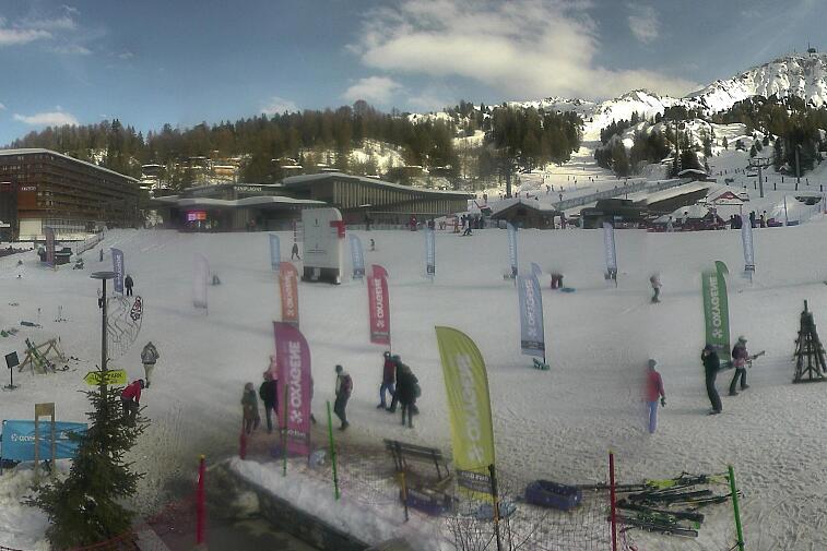 Webcam view across La Plagne centre piste-front. On the left you'll be able to see local ski schools giving lessons. The peak in the middle is La Grande Rochette. On the right is the Stade piste.