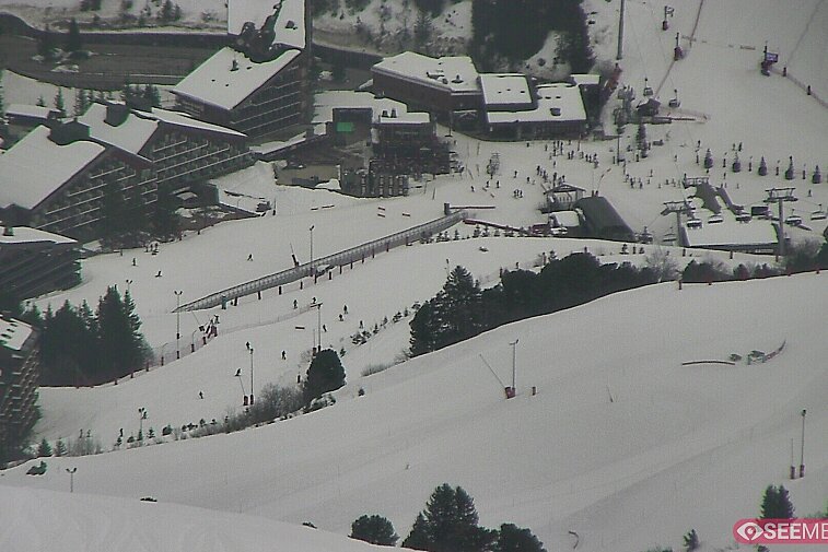 bottom of ski pistes with hotels in the background