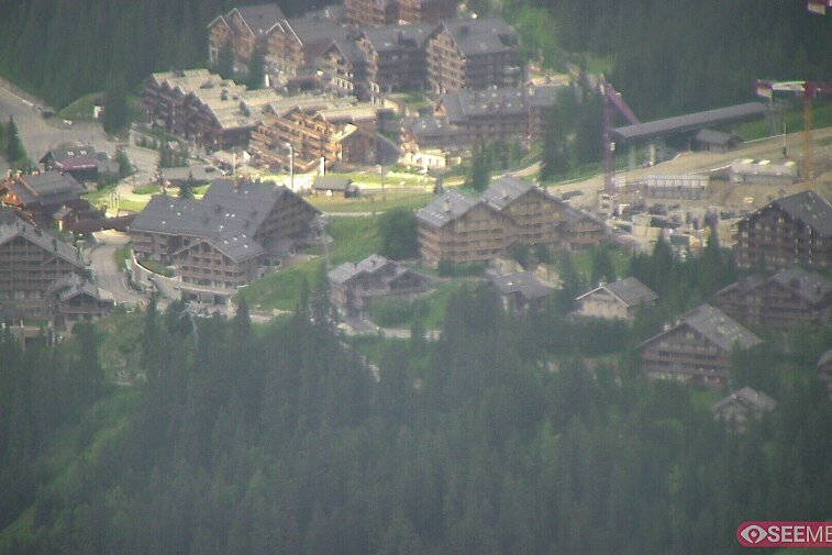 Webcam view showing the meeting point of several ski runs into Meribel, and part of the upper reaches of the resort