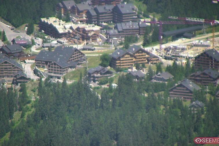Webcam view showing the meeting point of several ski runs into Meribel, and part of the upper reaches of the resort