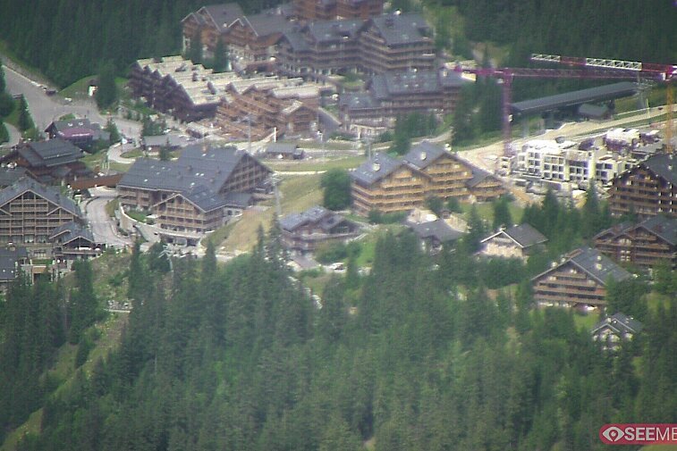 Webcam view showing the meeting point of several ski runs into Meribel, and part of the upper reaches of the resort