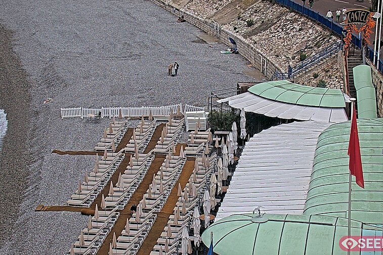 Webcam view of the Castel beach and club on the eastern-most side of the Promenade des Anglais and nestled under the Parc du Chateau, in Nice, France