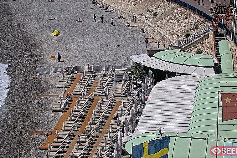 Webcam view of the Castel beach and club on the eastern-most side of the Promenade des Anglais and nestled under the Parc du Chateau, in Nice, France