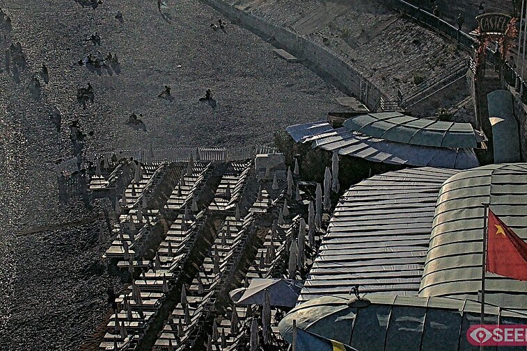 Webcam view of the Castel beach and club on the eastern-most side of the Promenade des Anglais and nestled under the Parc du Chateau, in Nice, France