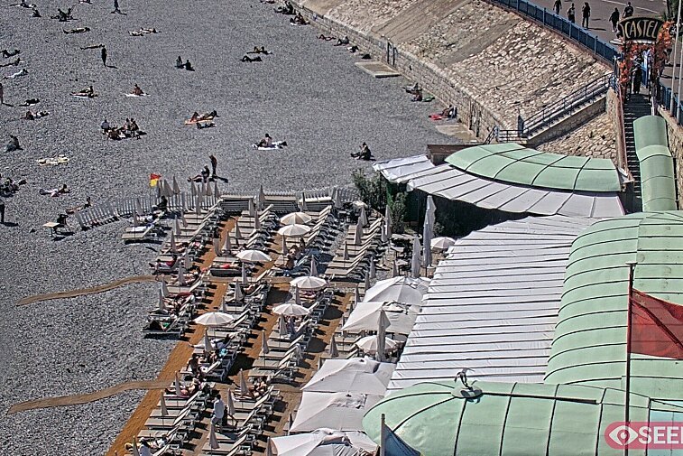 Webcam view of the Castel beach and club on the eastern-most side of the Promenade des Anglais and nestled under the Parc du Chateau, in Nice, France