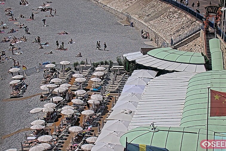 Webcam view of the Castel beach and club on the eastern-most side of the Promenade des Anglais and nestled under the Parc du Chateau, in Nice, France