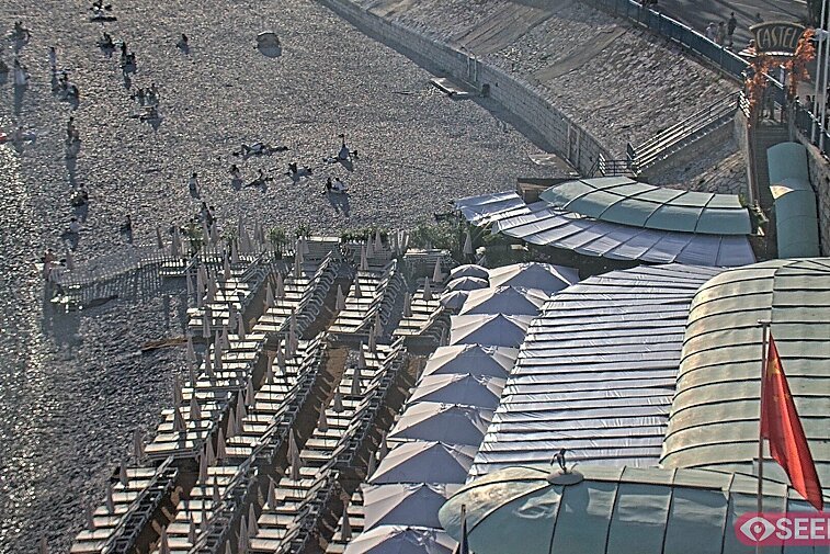 Webcam view of the Castel beach and club on the eastern-most side of the Promenade des Anglais and nestled under the Parc du Chateau, in Nice, France