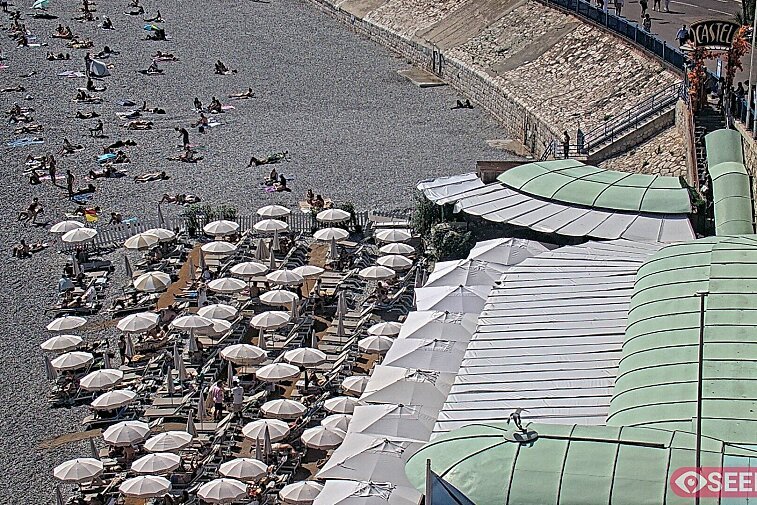 Webcam view of the Castel beach and club on the eastern-most side of the Promenade des Anglais and nestled under the Parc du Chateau, in Nice, France