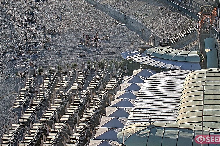 Webcam view of the Castel beach and club on the eastern-most side of the Promenade des Anglais and nestled under the Parc du Chateau, in Nice, France