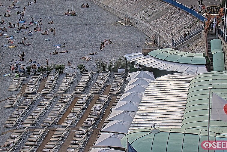 Webcam view of the Castel beach and club on the eastern-most side of the Promenade des Anglais and nestled under the Parc du Chateau, in Nice, France