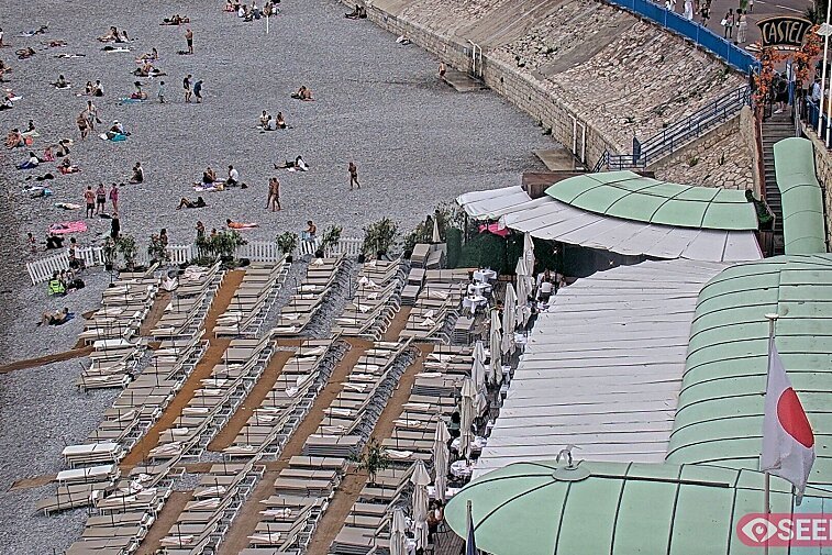 Webcam view of the Castel beach and club on the eastern-most side of the Promenade des Anglais and nestled under the Parc du Chateau, in Nice, France