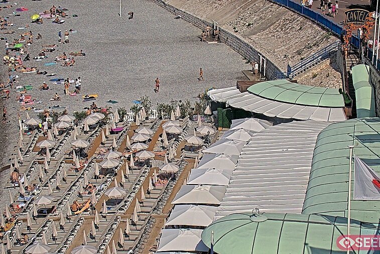 Webcam view of the Castel beach and club on the eastern-most side of the Promenade des Anglais and nestled under the Parc du Chateau, in Nice, France