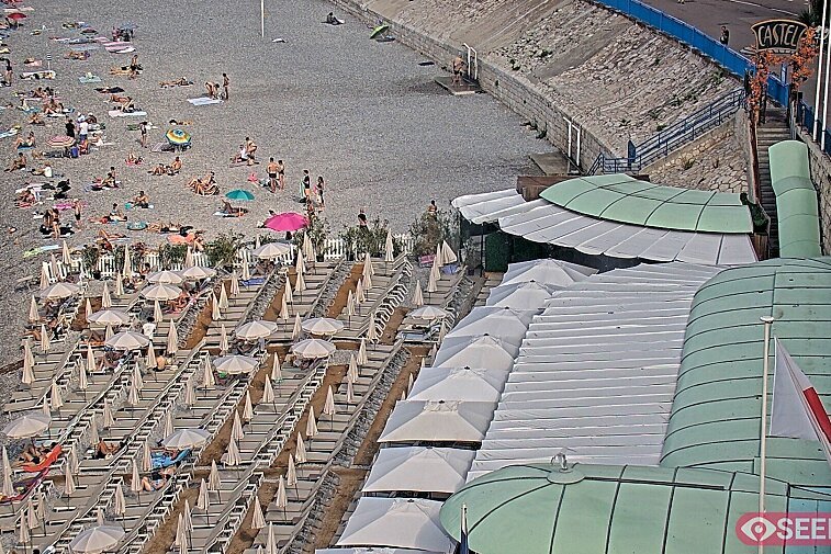 Webcam view of the Castel beach and club on the eastern-most side of the Promenade des Anglais and nestled under the Parc du Chateau, in Nice, France
