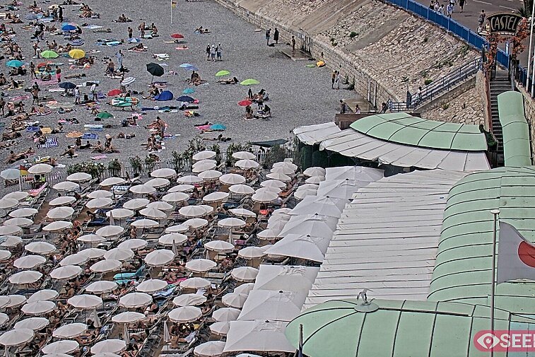Webcam view of the Castel beach and club on the eastern-most side of the Promenade des Anglais and nestled under the Parc du Chateau, in Nice, France