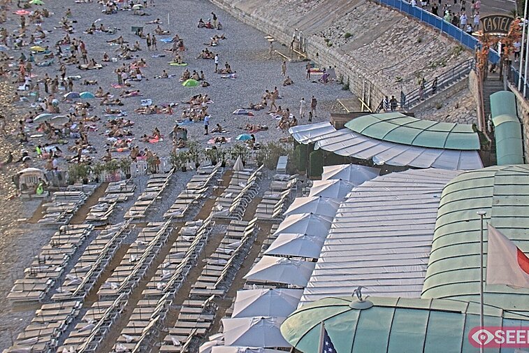 Webcam view of the Castel beach and club on the eastern-most side of the Promenade des Anglais and nestled under the Parc du Chateau, in Nice, France