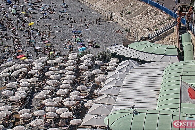 Webcam view of the Castel beach and club on the eastern-most side of the Promenade des Anglais and nestled under the Parc du Chateau, in Nice, France