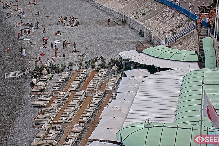 Webcam view of the Castel beach and club on the eastern-most side of the Promenade des Anglais and nestled under the Parc du Chateau, in Nice, France