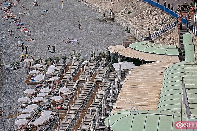 Webcam view of the Castel beach and club on the eastern-most side of the Promenade des Anglais and nestled under the Parc du Chateau, in Nice, France
