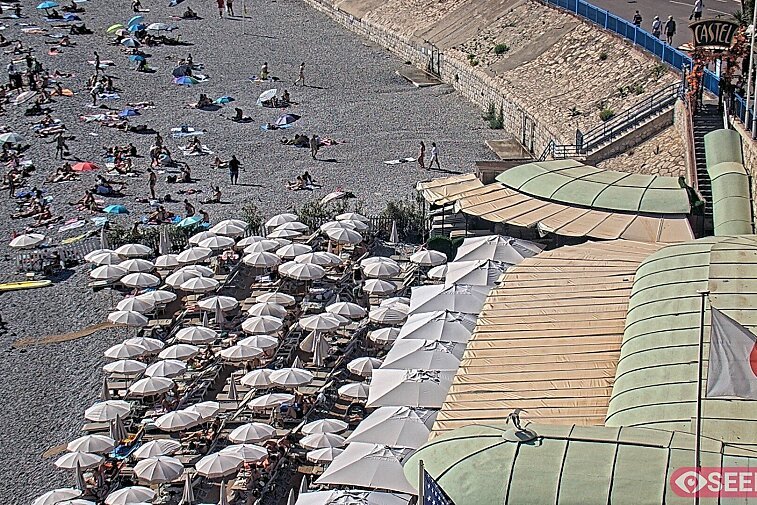 Webcam view of the Castel beach and club on the eastern-most side of the Promenade des Anglais and nestled under the Parc du Chateau, in Nice, France