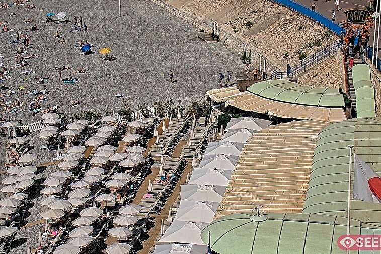 Webcam view of the Castel beach and club on the eastern-most side of the Promenade des Anglais and nestled under the Parc du Chateau, in Nice, France