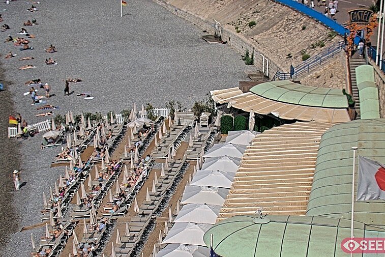 Webcam view of the Castel beach and club on the eastern-most side of the Promenade des Anglais and nestled under the Parc du Chateau, in Nice, France