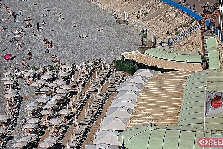 Webcam view of the Castel beach and club on the eastern-most side of the Promenade des Anglais and nestled under the Parc du Chateau, in Nice, France