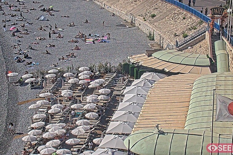 Webcam view of the Castel beach and club on the eastern-most side of the Promenade des Anglais and nestled under the Parc du Chateau, in Nice, France
