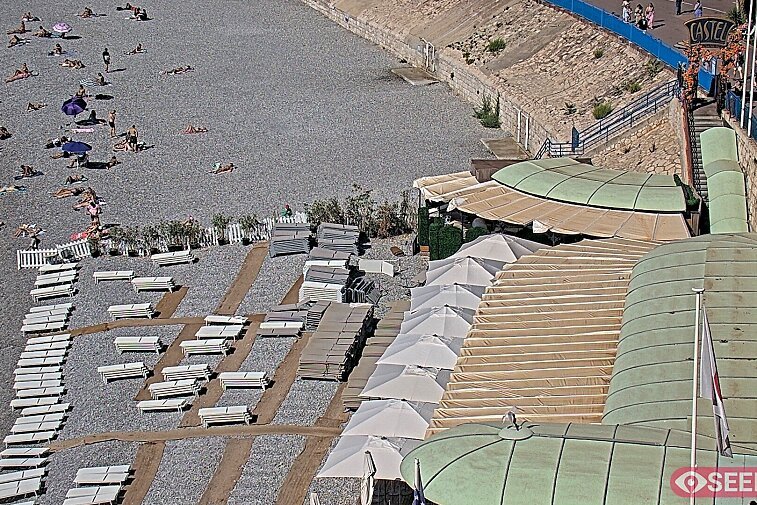 Webcam view of the Castel beach and club on the eastern-most side of the Promenade des Anglais and nestled under the Parc du Chateau, in Nice, France