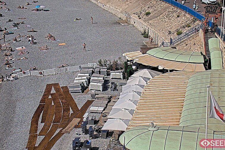 Webcam view of the Castel beach and club on the eastern-most side of the Promenade des Anglais and nestled under the Parc du Chateau, in Nice, France